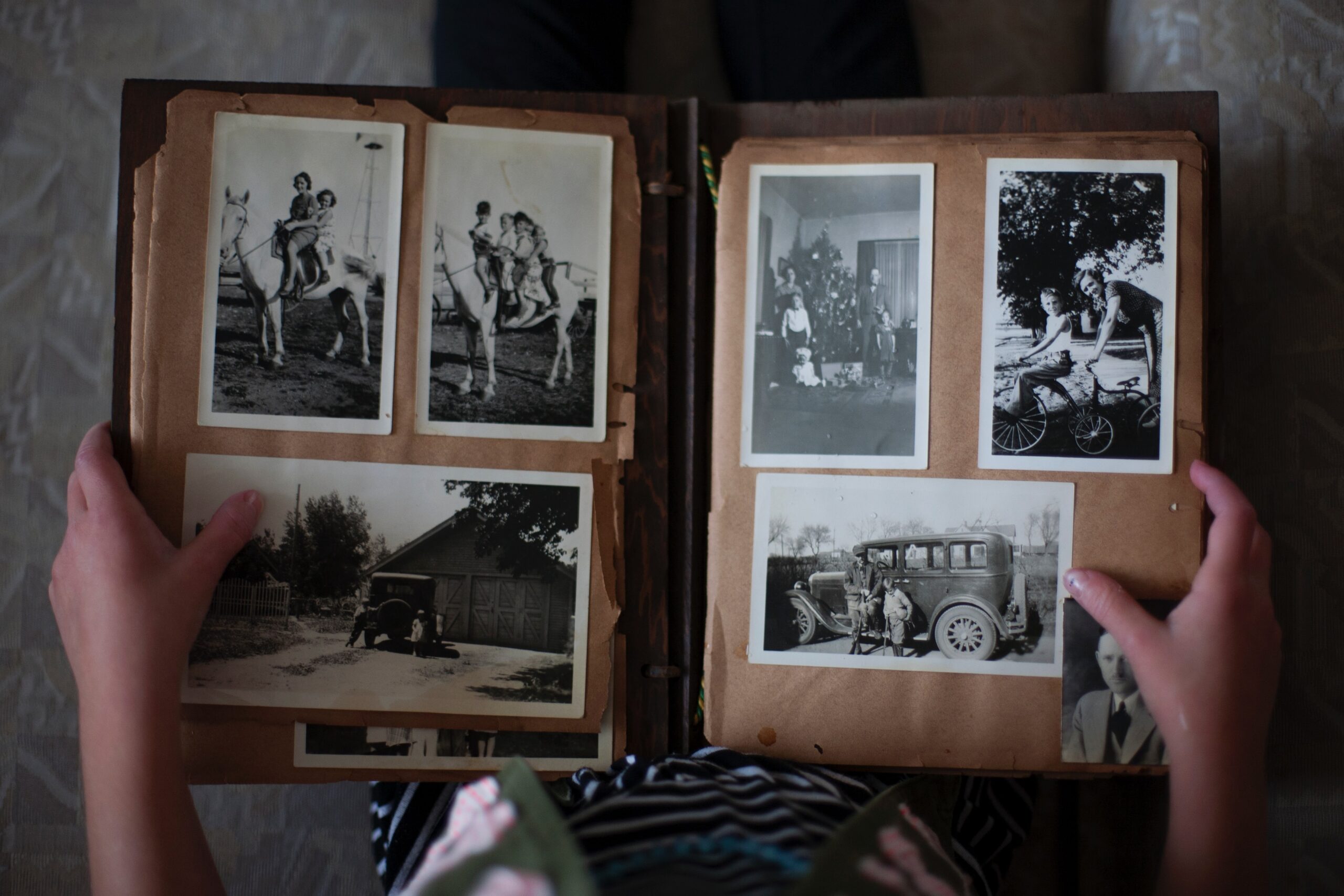 An open photo album with old black-and-white photos in it