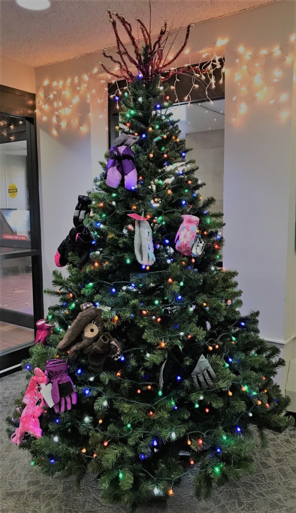 Keeping Our Communities WarmChristmas tree with mittens hanging on the branches
