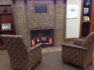 Two arm chairs facing the fireplace at the Dwight Foster Library