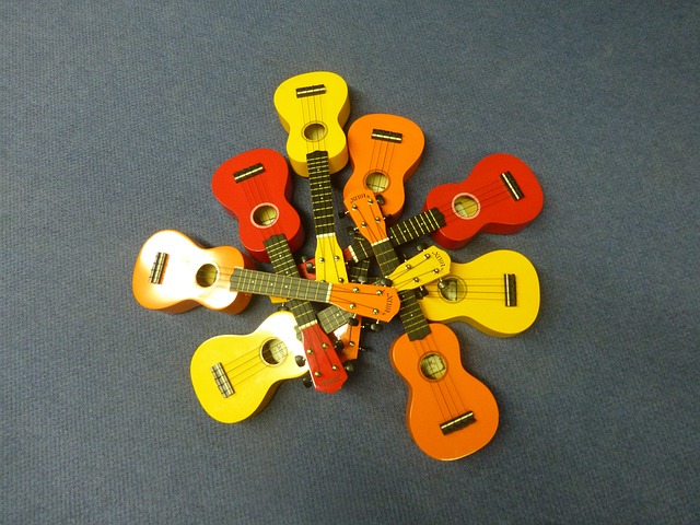 A number of ukuleles, red, orange, and yellow, in a circle