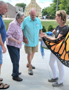 A photo of Memory Café attendees viewing butterflies outside at the Watertown Public Library.