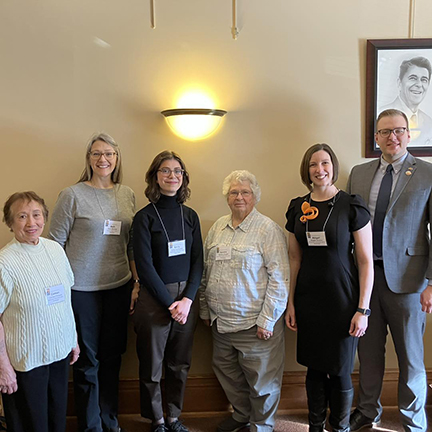 Photo of a group of library staff and supporters with Wisconsin Representative Nik Rettinger.