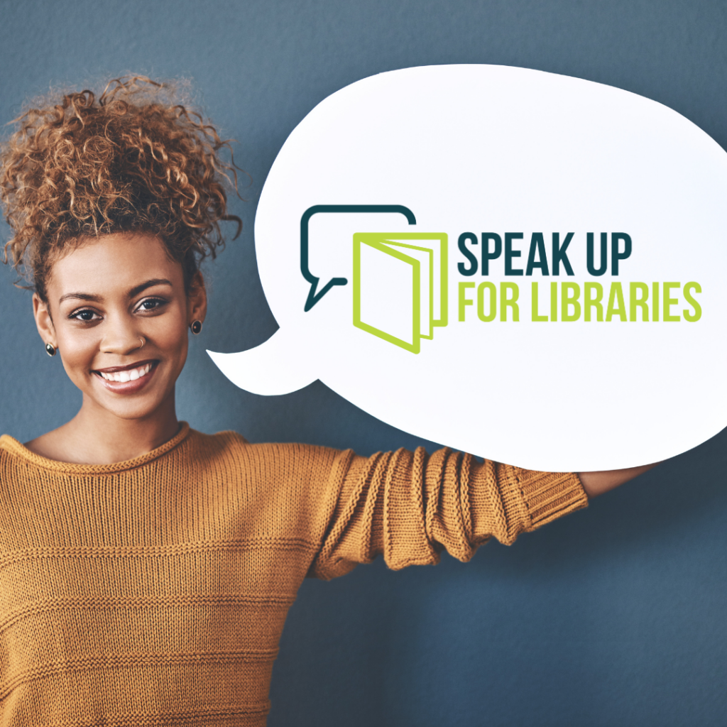 Person holding a sign in the shape of a speech bubble with the Speak Up For Libraries logo on it with a book icon overlapping a speech bubble icon.