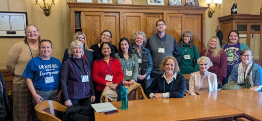 A large group of library staff and trustees with Denise, Senator Chris Kapenga's staff, inside the Wisconsin State Capitol building in Madison.